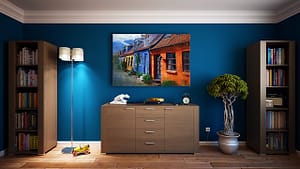 Blue-colored room with table and bookshelf against the wall