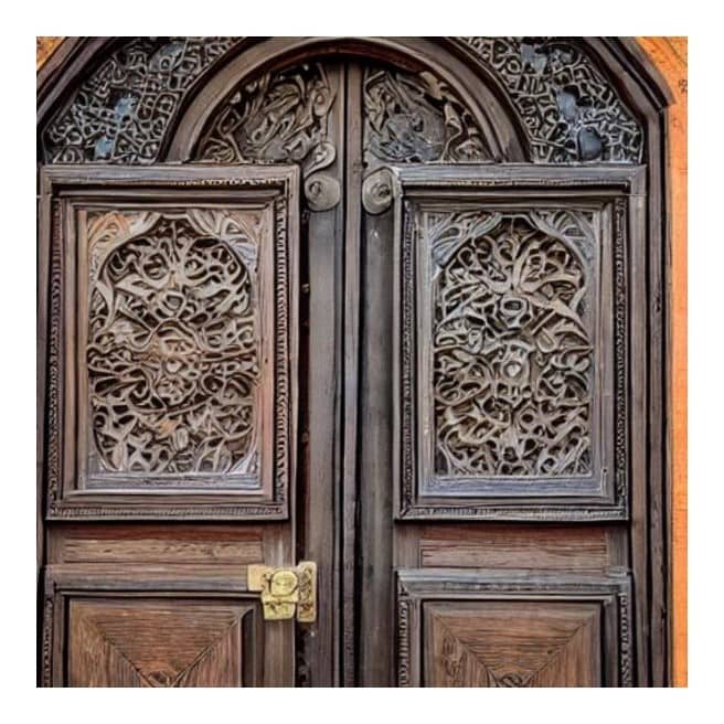 A close-up of intricate wooden carvings on a door or window